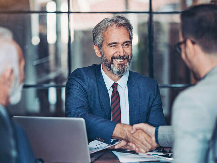 Executive stretching hands with another person